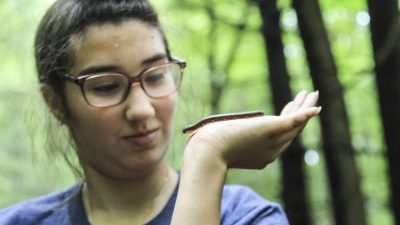 student holding a millipede