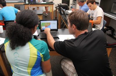 two people looking at a computer map